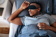 © C Malambo/peopleimages.com - Sleeping in is my favourite pastime. Cropped shot of a handsome young man wearing a night mask and sleeping in his bed at home.