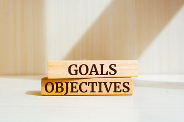 Wall Mural - Wooden blocks with words 'Goals and Objectives'.