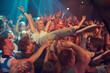 © Nicola Katie/peopleimages.com - Own the night. Cropped shot of a woman crowd surfing at a music festival.