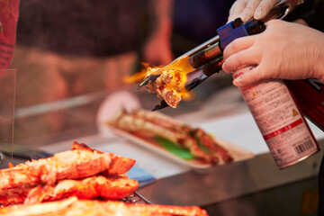 Wall Mural - Grilled king crab legs displayed in a traditional market