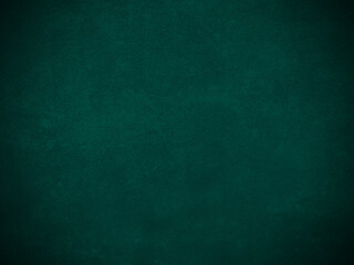 Dark green old velvet fabric texture used as background. Empty green fabric background of soft and smooth textile material. There is space for text...