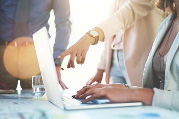 Lets check out that website. Cropped shot of unrecognizable businesspeople discussing something on a laptop.