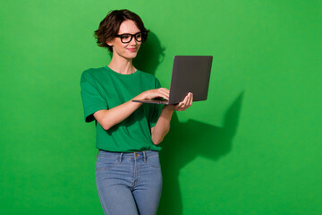 Poster - Photo of shiny confident young lady dressed casual t-shirt working modern gadget empty space isolated green color background