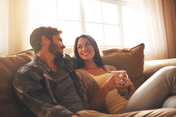 Wall Mural - I love these moment. Cropped shot of a young couple relaxing on the sofa at home.