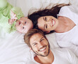 © Marius Venter/peopleimages.com - And baby makes three. High angle portrait of a young couple and their baby boy in the bedroom.