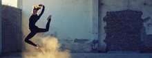 Ballerina Jumping And Dancing In A Dusty Abandoned Building On A Sunny Day