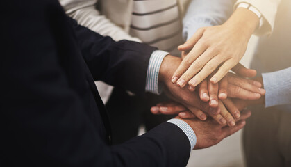 Poster - Where there is unity there is victory. Cropped shot of a group of businesspeople putting their hands together in unity.