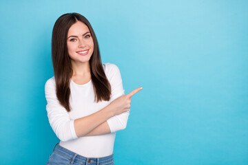 Wall Mural - Portrait of attractive cheerful girl showing copy blank empty space ad offer isolated over brigth blue color background