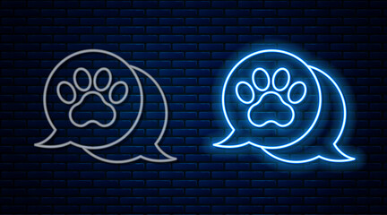 Poster - Glowing neon line Paw print icon isolated on brick wall background. Dog or cat paw print. Animal track. Vector