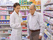 Each and every client is special. Shot of a young pharmacist helping an elderly customer.