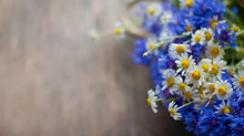 Cornflowers And Chamomile On Wooden Background