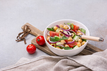 Wall Mural - Healthy vegetarian salad with cooked chickpeas, parsley, cherry tomatoes, onion, fresh cucumber and olives