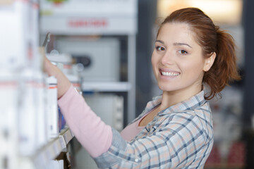 portrait of young woman worker in store