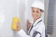 portrait of female builder using sponge on wall