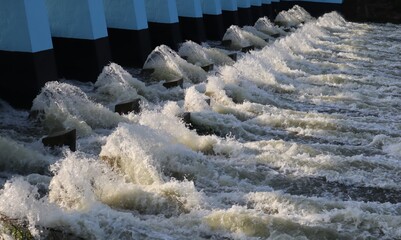 Beautiful view of river water flowing out of the dam.