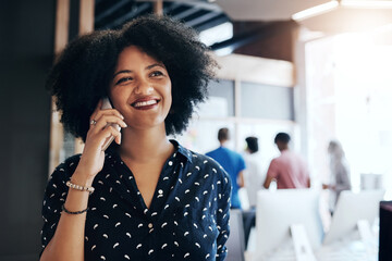 Poster - Yes I like the sound of that too. Shot of an attractive young female designer taking a phone call in the office.