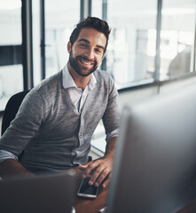 Success is created by the effort you put in. Portrait of a young businessman working on a computer in an office.