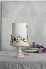 Poster - White wedding cake with lillac and green flowers