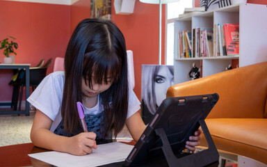 Girl studying online using a computer.