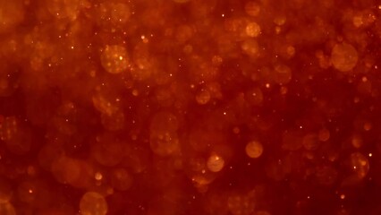 Wall Mural - Golden Particles Movement In Red liquid. Gold dust particles and bokeh moving slowly in red fluid. Abstract relaxing background. 