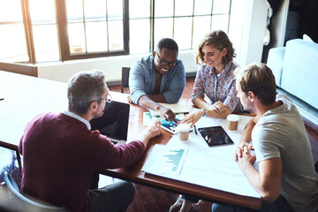 Wall Mural - Theyre the team for the job. Shot of a creative team having a brainstorming session in the boardroom.