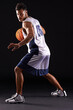 © Duncan M/peopleimages.com - Defend defend defend. Studio shot of a basketball player against a black background.