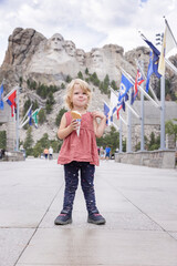 Little girl sightseeing at Mount Rushmoor National Memorial, eating an ice cream on vacation