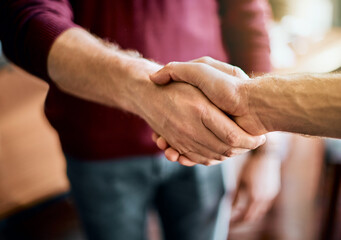 Poster - Heres to a successful project. Closeup of two unrecognizable peoples hands greeting and shaking hands inside of a office at work.