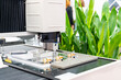 © Surasak - High technology precision video measuring machine with visual camera sensitive probe sensor during product inspection dimension shape appearance etc. for quality control of manufacturing process