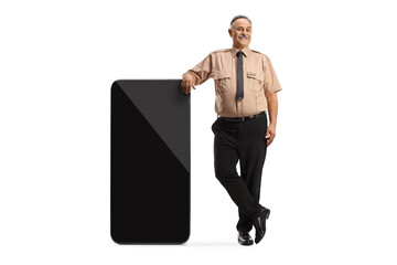 Wall Mural - Security officer leaning on a big mobile phone and pointing