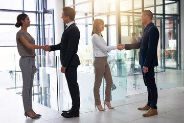 Aufkleber - Reaching for greater opportunities together. Shot of a group of businesspeople shaking hands in an office.