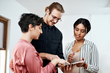 Poster - Lets start with this on here. Cropped shot of a diverse group of businesspeople standing together and using a tablet in the office.