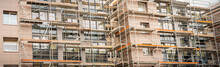 Banner. Building Under Construction With Scaffolds.Scaffolding On Multi Storey Building Facade During Renovation.