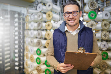 Poster - Inventory is done. Portrait of a manager holding a clipboard while standing in front of wire spools on the factory floor.
