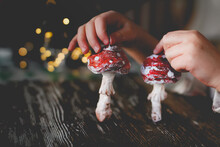 Amanita Muscaria Made Of Cotton Wool In His Hands On Blurred Background. Retro Handmade Christmas Toys
