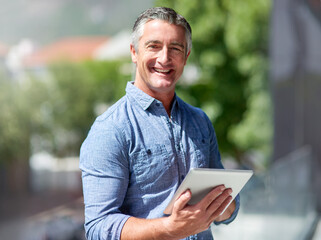 Aufkleber - Wireless technology keeps my daily tasks streamlined. Portrait of a casually dressed businessman using a digital tablet outside.