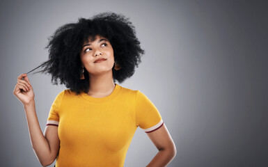 Wall Mural - Her hair is bold and her confidence is beautiful. Studio shot of an attractive young woman posing against a grey background.