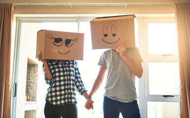 Poster - Now thats thinking outside the box. Shot of a happy young couple having fun with boxes while moving into their new house.