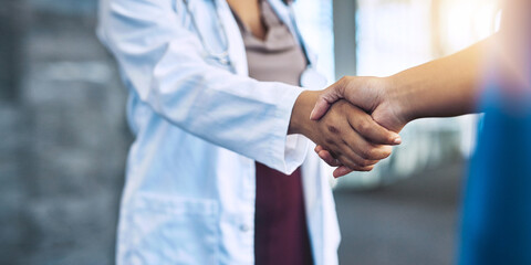 Wall Mural - I look forward to working with you in the operation room. Closeup shot of two medical practitioners shaking hands.