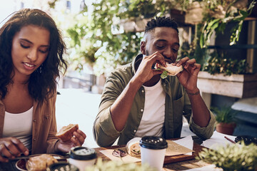 Aufkleber - Cant say no to a good sandwich. Cropped shot of a happy young couple out for lunch at a cafe.