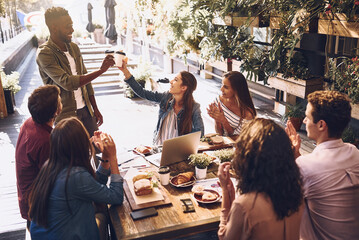 Poster - I really like your drive. Shot of a group of creative workers having a meeting over lunch in a cafe.