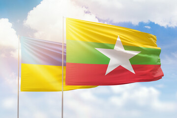 Sunny blue sky and flags of myanmar and ukraine