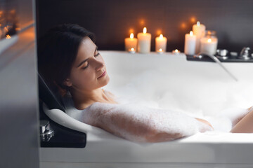 Wall Mural - Beautiful woman taking bubble bath. Romantic atmosphere