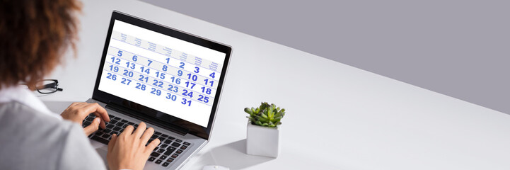 Businesswoman Looking At Calendar With Daily Agenda