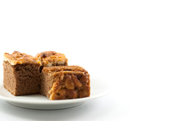 Toffee cake in white ceramic plate on a white background.