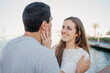© Roman Tyukin - A stylish young man is holding hands with his brunette girlfriend in the port
