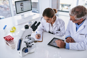 Aufkleber - Making a full detailed analysis of their latest findings. Shot of two scientists having a discussion in a lab.