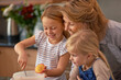 © Marius V/peopleimages.com - A joyful kitchen experience. Shot of two little girls baking cupcakes with their grandmother at home.