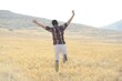© Zubaida - Young man jumping on yellow meadow
