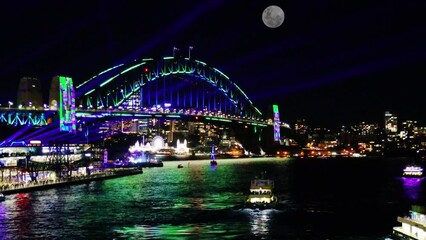 Wall Mural - Colourful Light show at night on Sydney Harbour NSW Australia. The bridge illuminated with lasers and neon coloured lights 